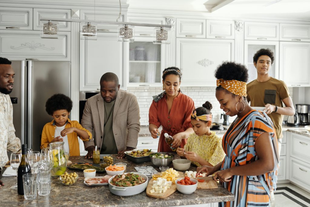 host family preparing a topical meal from their country